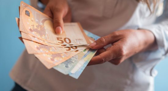 girl holding euro banknotes in her hands